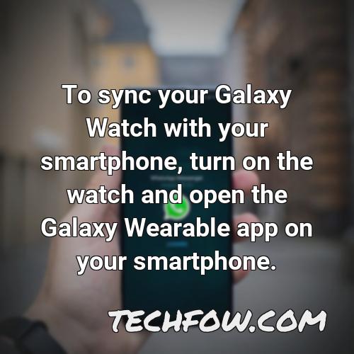to sync your galaxy watch with your smartphone turn on the watch and open the galaxy wearable app on your smartphone